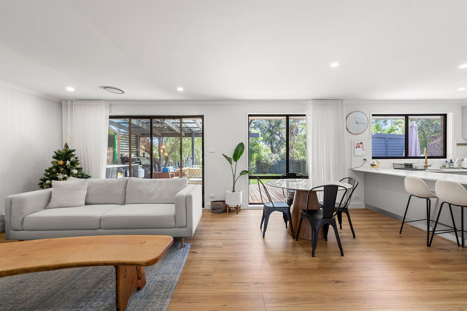 A bright open-plan living and kitchen area in a Canberra home