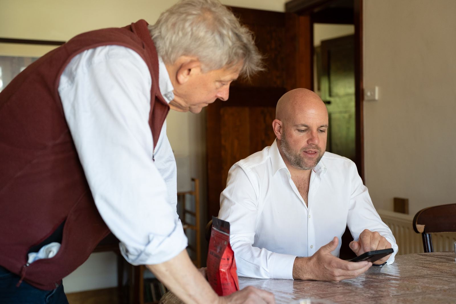 Steve Lowe talking through a sale plan with a home owner at their kitchen table