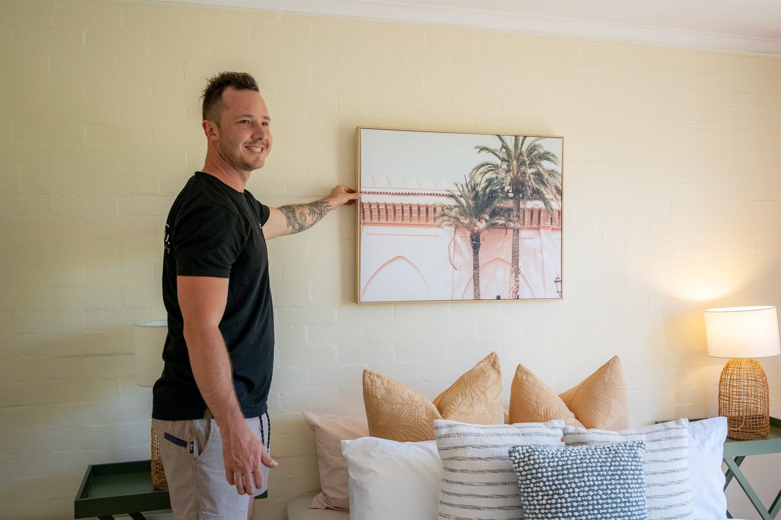 Hanging artwork while styling a Canberra home for sale